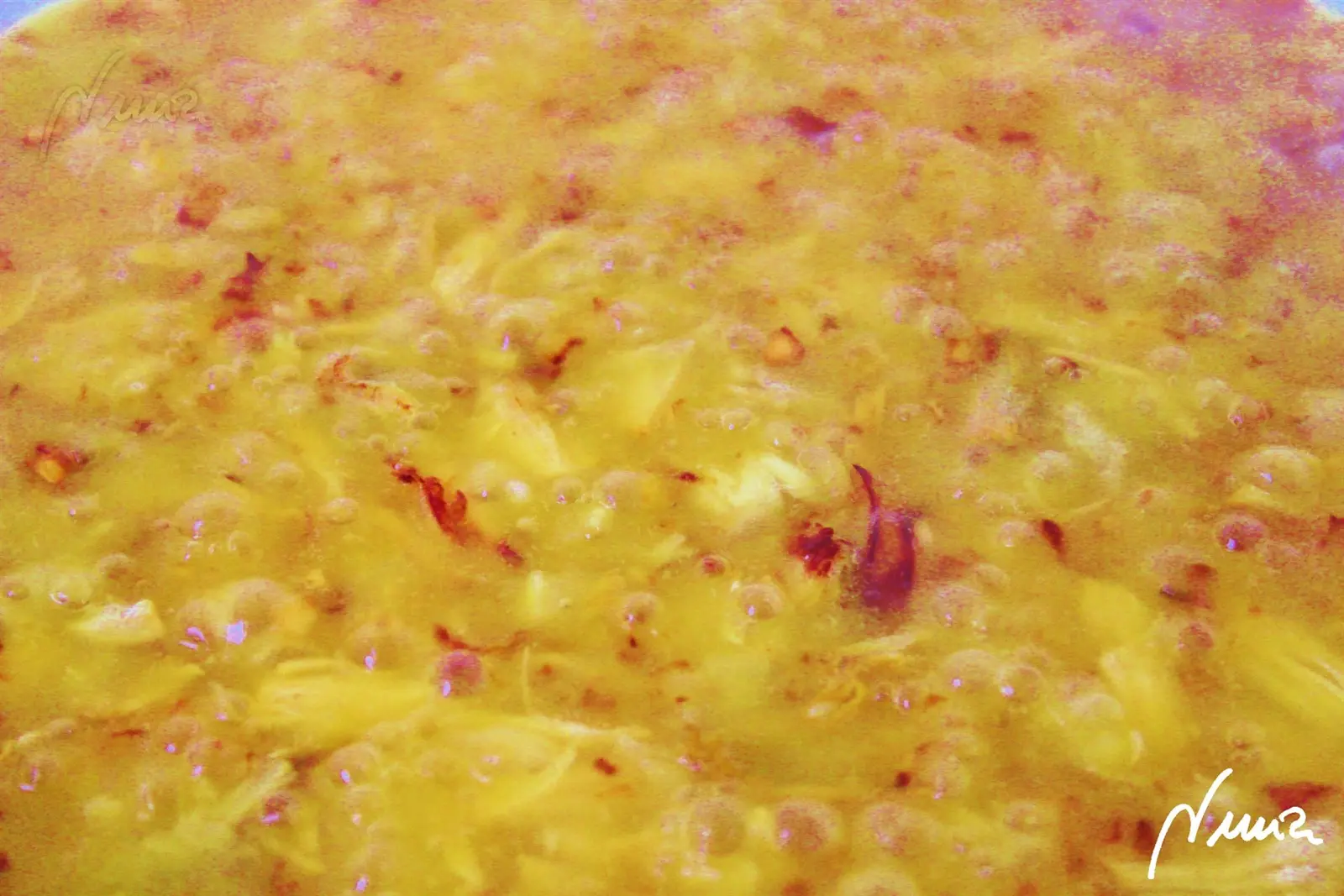 Arroz con conejo, paso 7: Echar el caldo hirviendo y el azafrán y dejar cocer a fuego medio durante 16 minutos: