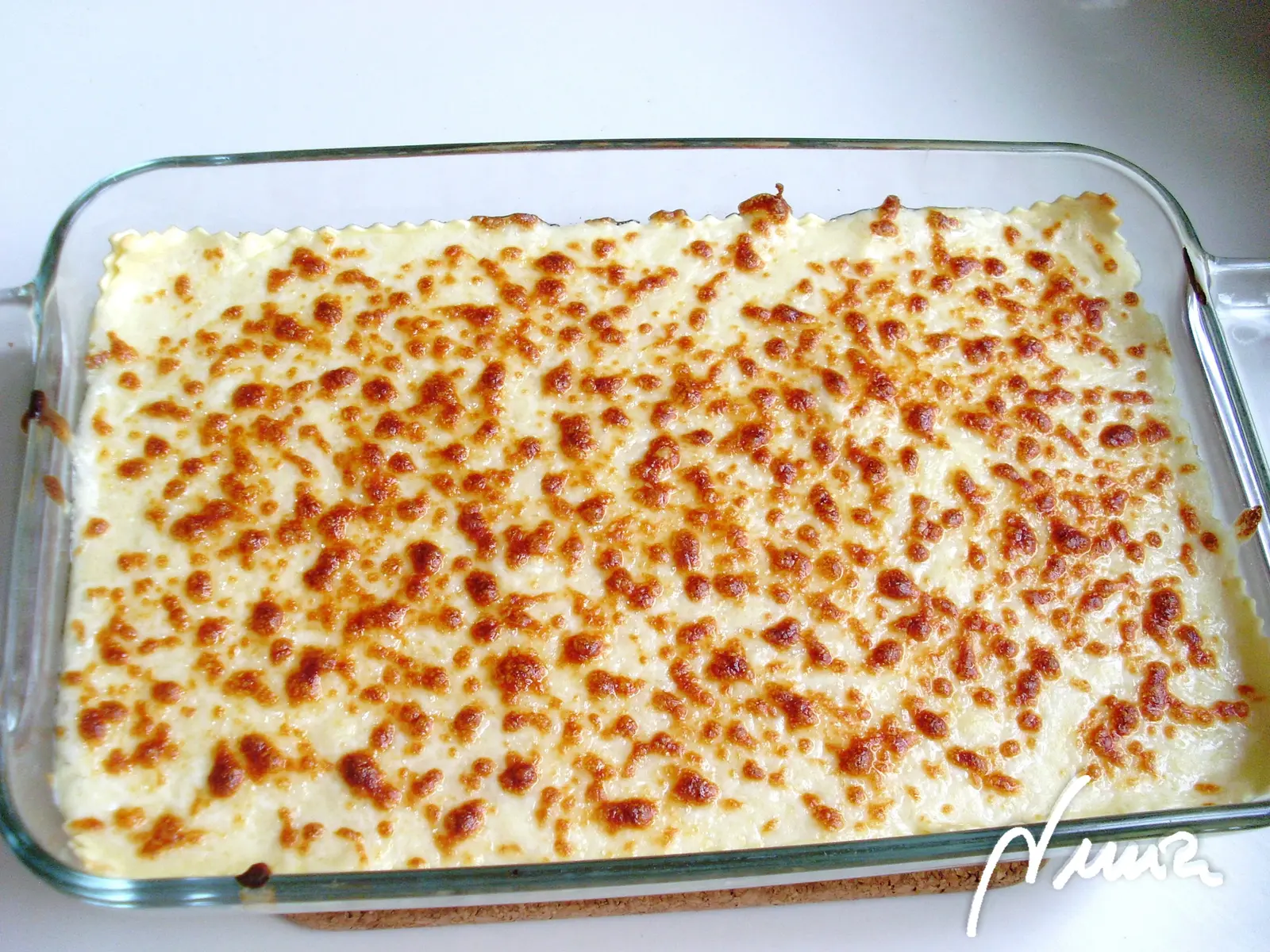 Lasaña de espinacas con piñones, paso 13: Repartir el queso rallado por encima. -9-.